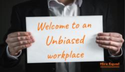 Person holding sign, welcome to an unbiased workplace